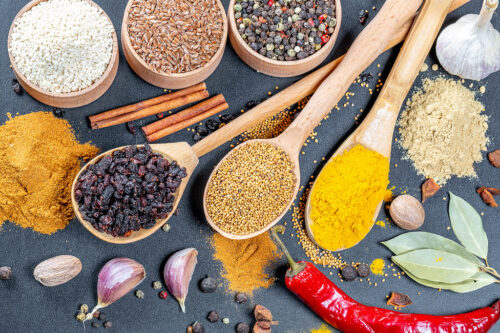 Multi-colored spices for healthy and tasty cooking on a black ba Multi-colored spices for healthy and tasty cooking on a black background